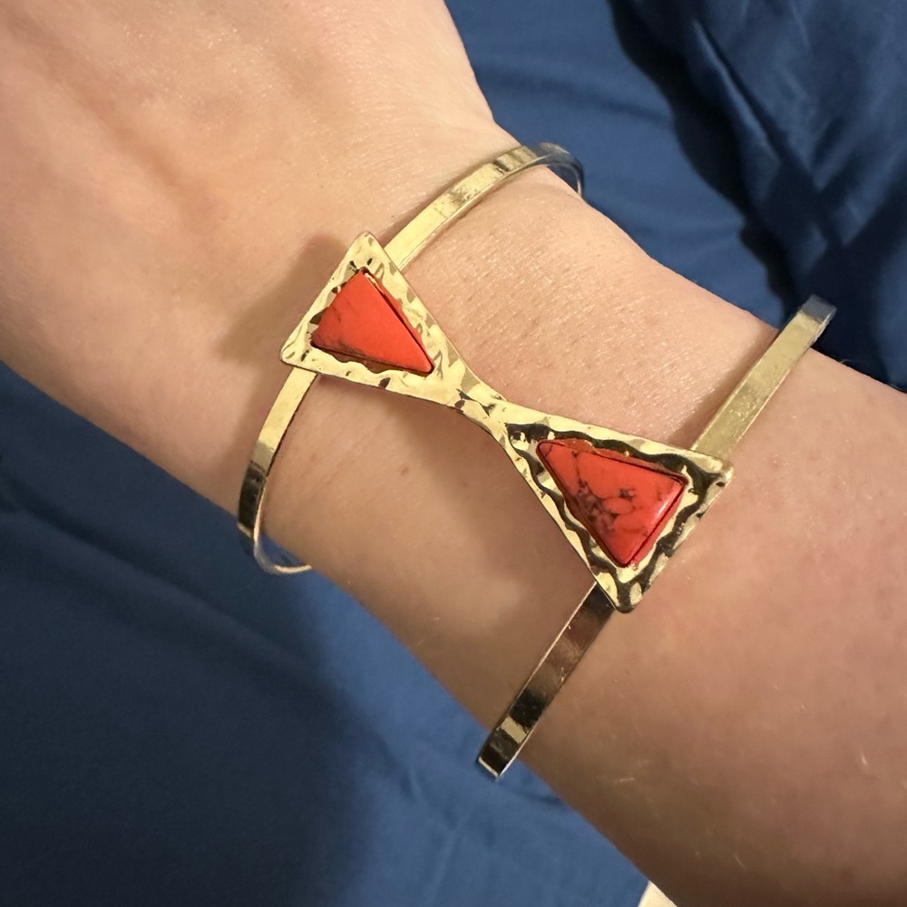 Gold plated cuff bracelet with red Aztec design stone accent